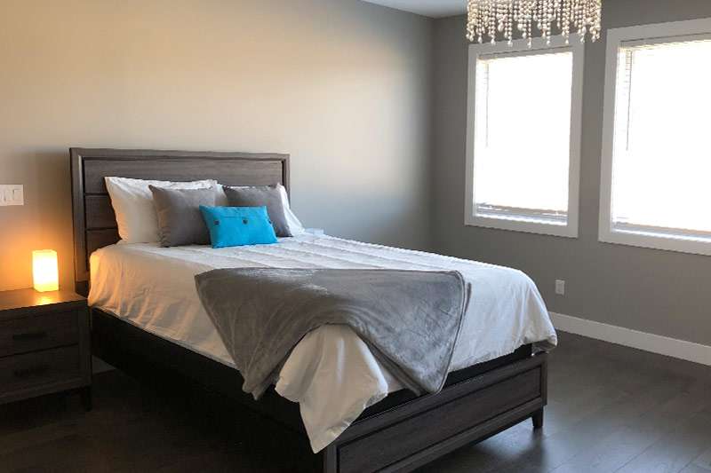 View of a bedroom with a bed and nightstand on the left