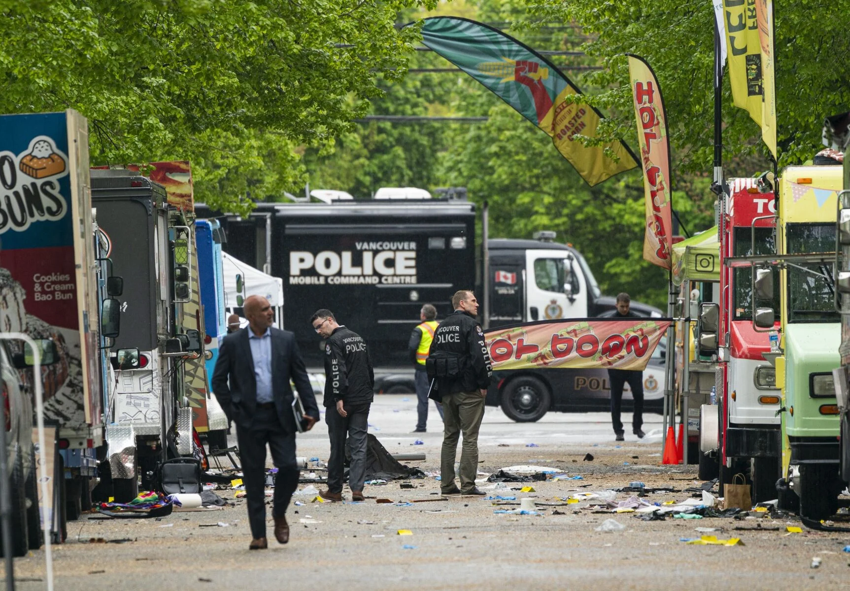 Vancouver Police detectives walk along where a car drove through a crowd killing multiple people on the weekend in Vancouver on Monday. Rich Lam The Canadian Press